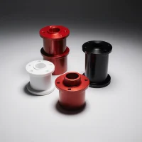 CNC machined parts with powder-coated surfaces in red, black, and white